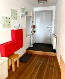 a room with a red cabinet and a door at Una in Vienna