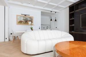 a white living room with a white couch and a table at Knightsbridge - Sumptuous Flat - Hyde Park in London