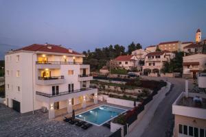 an aerial view of a building with a swimming pool at Villa Barbara & Zoran with heated swimming pool in Seget Vranjica