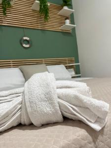 a white blanket laying on top of a bed at IL COVO DEL PESCATORE in Pozzuoli +19 photos