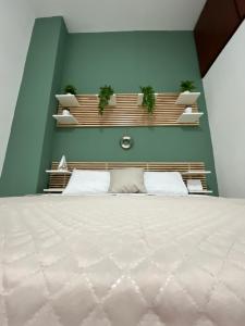 a bedroom with a bed with plants on the wall at IL COVO DEL PESCATORE in Pozzuoli