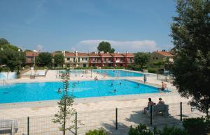 a large swimming pool with people in it at Villaggio Michelangelo in Bibione