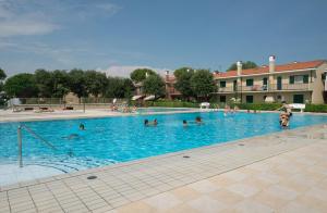 a group of people swimming in a swimming pool at Villaggio Michelangelo in Bibione