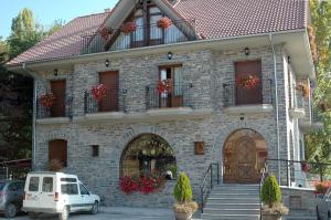 a white car parked in front of a building at Hotel Restaurante Santa Elena in Sabiñánigo