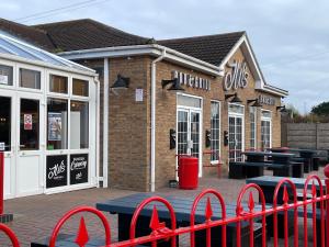 a row of stores with ping pong tables in front of them at Golden Palm Resort TM5 in Chapel Saint Leonards