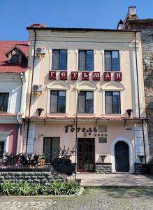 a building with a sign on the front of it at Hetman Hotel in Kamianets-Podilskyi