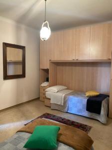 a bedroom with a bed and a mirror at CASA DELLA PIAZZA in Bagnone