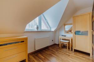 a attic room with a desk and a window at Apartament Bukowa Mountain Wisla in Wisła