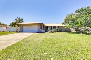 a house with a garage and a grass yard at Sarasota House with Private Pool - 4 Mi to Beach! in Sarasota
