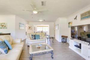 a living room with a couch and a table at Sarasota House with Private Pool - 4 Mi to Beach! in Sarasota