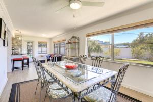 a dining room and living room with a table and chairs at Sarasota House with Private Pool - 4 Mi to Beach! in Sarasota