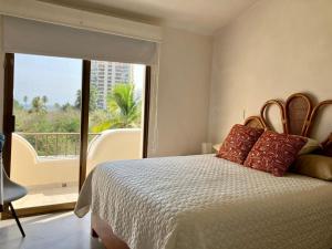 Un pat sau paturi într-o cameră la Villa Flamingo Golf Ixtapa