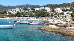 a group of boats in the water at a beach at Euphoria beach house in Paleo Tsifliki