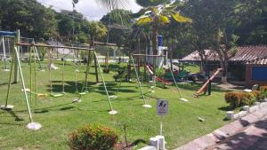 a playground with a swing set in a park at Cabaña Campestre in La Pintada