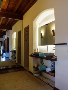 a bathroom with a sink and a mirror at Casa del Armiño Mansión de la Familia de "El Greco" in Toledo