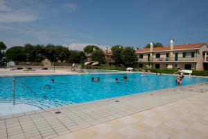 a group of people in a swimming pool at Villaggio Michelangelo in Bibione