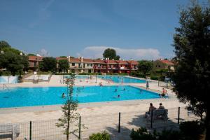 a large swimming pool with people in it at Villaggio Michelangelo in Bibione