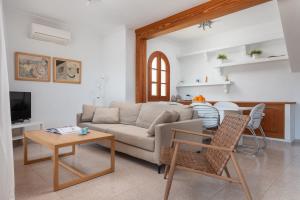 a living room with a couch and a table at SES ONES with sea views in Alcudia