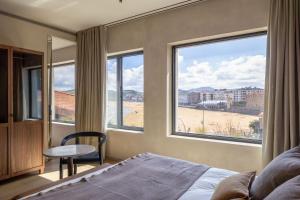 een slaapkamer met een bed en uitzicht op het strand bij Hotel Ur Bare in Zarautz