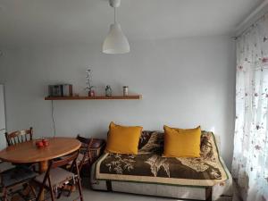 a living room with a couch and a table at Nocleg na działce w miasteczku in Kock