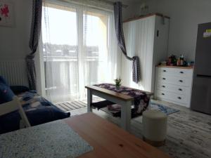 a bedroom with a table in front of a window at Dreapart Pruszcz gdański in Pruszcz Gdański