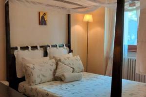 a bedroom with a canopy bed with pillows at Ca'de Picchio in Arezzo