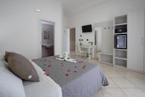 a bedroom with a bed with red roses on it at B&B Il Gabbiano in Porto Cesareo
