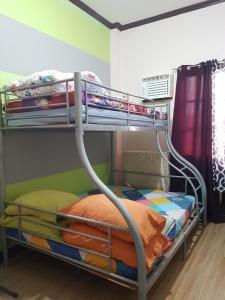 a bunk bed in a room with a bunk bedscribed at JZA Transient House in Cagayan de Oro