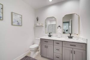 a bathroom with a toilet and a sink and mirrors at South West Florida Family Home, 3 Bedroom,2 Bathroom, King bed suite, Close to Beaches, Parks, Fishing, Golfing, Kayaking in Rotonda West +42 photos
