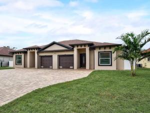 a house with a palm tree in front of it at South West Florida Family Home, 3 Bedroom,2 Bathroom, King bed suite, Close to Beaches, Parks, Fishing, Golfing, Kayaking in Rotonda West