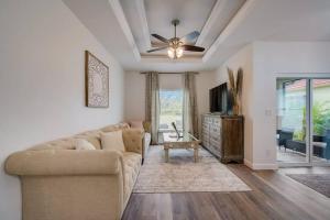 a living room with a couch and a tv at South West Florida Family Home, 3 Bedroom,2 Bathroom, King bed suite, Close to Beaches, Parks, Fishing, Golfing, Kayaking in Rotonda West