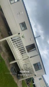 a tall white building with windows on the side of it at Whitehouse Leisure Park North wales 6 birth caravan in Kinmel Bay