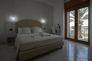 una camera con un grande letto e un balcone di B&B Il Gabbiano a Porto Cesareo