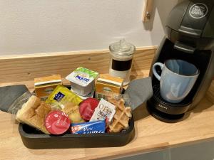 a tray of food sitting on a counter next to a coffee maker at Studio Le Roof - Une vue splendide - Petit déjeuner inclus 1ère nuit - AUX 4 LOGIS in Foix