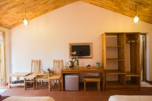 a dining room with a table and a tv at La Mer Resort, Phú Quốc in Phú Quốc