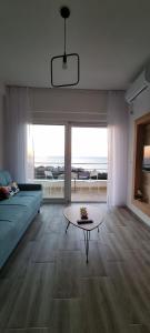 a living room with a couch and a table at Cold Bay Mansion Luxury Sea View Suites in Bar