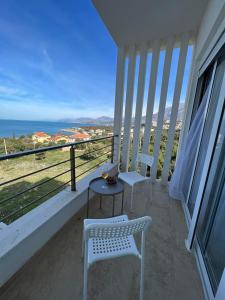 a balcony with two chairs and a table and the ocean at Cold Bay Mansion Luxury Sea View Suites in Bar
