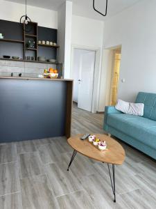 a living room with a blue couch and a table at Cold Bay Mansion Luxury Sea View Suites in Bar