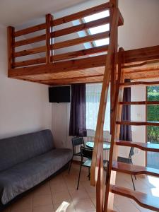 salon z łóżkiem na podwyższeniu i kanapą w obiekcie Słoneczne Apartamenty w mieście Mielno