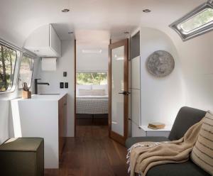 a tiny house with a kitchen and a living room at AutoCamp Yosemite in Midpines