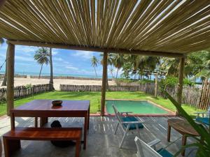 a patio with a table and chairs and a swimming pool at Os Navegantes -Casa Vento in Icaraí