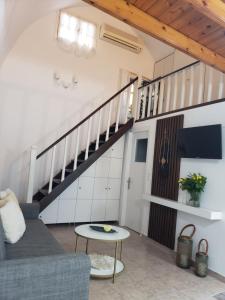 a living room with a couch and a staircase at SOFI'S house in Rhodes Town