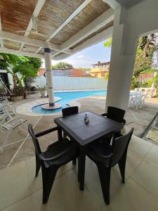 a table and chairs on a patio with a pool at La Casa de Luna in Carmen de Apicalá