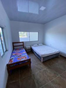 a bedroom with two beds in a room at La Casa de Luna in Carmen de Apicalá