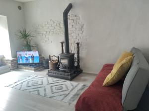 a living room with a fireplace and a couch at Up Stairs Double Apartment Innishannon Mariners Rest in Cork