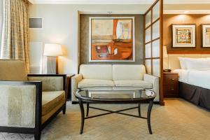 a hotel room with a bed and a couch and a coffee table at MGM Signature, Centrally Located, Strip Views NO RESORT FEE in Las Vegas