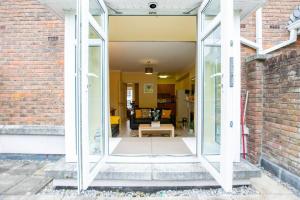 una puerta de cristal abierta a una sala de estar en 3 - Superb Duplex at Gort Na Coiribe by Shortstays, en Galway