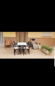 a patio with a table and chairs in a room at Apartamento daimus in Daimuz