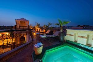 a swimming pool on the roof of a house at Riad Livia Marrakech - Adults Only in Marrakesh