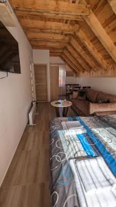 a bedroom with a bed and a living room at Iva Lux Apartments in Žabljak